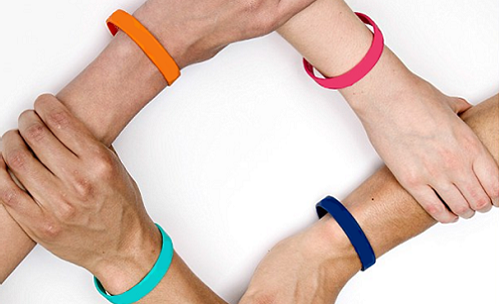 Group of four people joining together wearing silicone wristbands