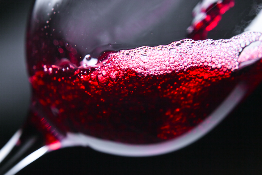 Red wine in wineglass on dark background