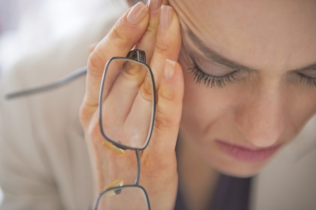 Closeup on stressed business woman with eyeglasses