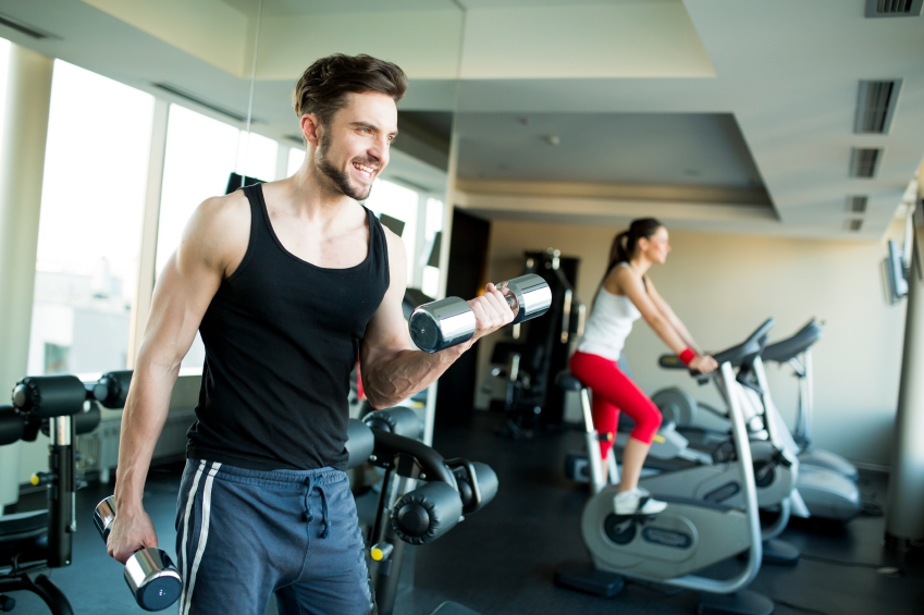 Man at the Gym Doing Weights Where Wristbands can be Worn