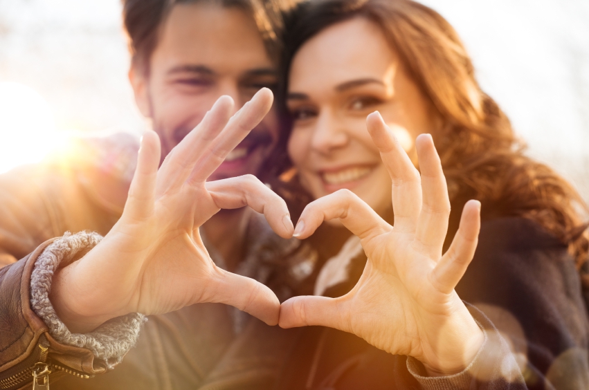 Loving Couple Making Heart Shape with Hands