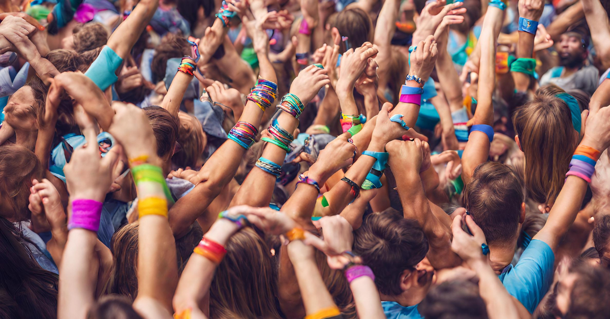 The different uses for silicone wristbands - shows a crowd wearing different coloured silicone wristbands